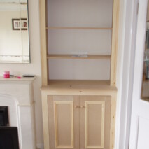 Framed alcove shelving with cupboards below